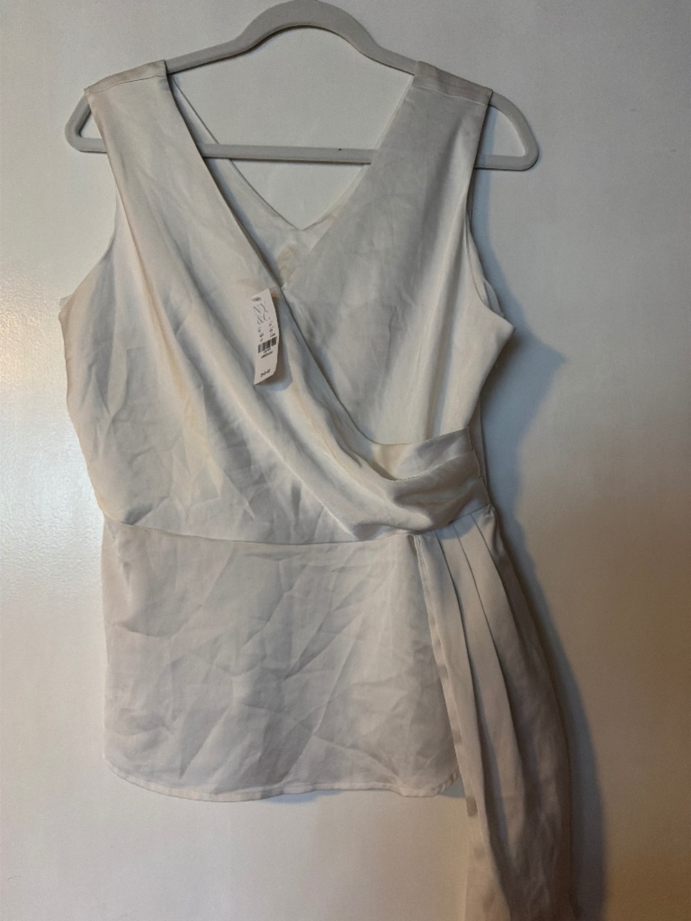 Elegant ivory/cream wrap-style sleeveless blouse/top